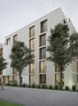 A modern, multi-story apartment building with a clean, minimalist design. The building features large windows and balconies, surrounded by trees and greenery. The exterior is primarily made of light-colored materials, creating a sleek and contemporary loo