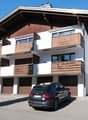 2 story house, white and brown, 3 garages, balcony, snow on the ground