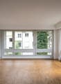 empty room, wooden floor, large windows, balcony, white walls, white ceiling