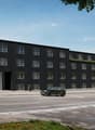 Modern architectural design, three-story residential building, large windows, entrance with awning, rooftop terrace