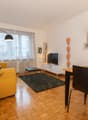 Wooden floor, yellow sofa, television, side table, dining table, floor lamp