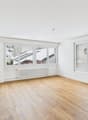 empty room, hardwood floors, white walls, large windows, radiator