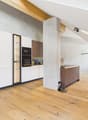 kitchen area with modern cabinets, hardwood floors, and built-in appliances