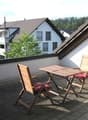 Balcony with table and chairs, view of the houses