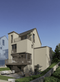 3 story house, beige exterior, multiple balconies, garden, outdoor seating area