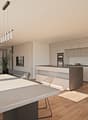 The image shows an open concept living room and kitchen area. The kitchen features modern, light-colored cabinets and a large island with a stone countertop. The living room has a large window that provides access to a balcony or terrace. The space has a