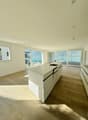 modern kitchen with island, large windows, modern appliances, wood floor, large open space