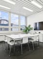 modern office room, white walls, large windows, white table, white chairs, whiteboard, TV, plant