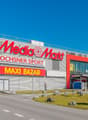 Retail complex with Media Markt, Ochsner Sport, and Maxi Bazar signage.
