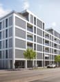 Modern apartment building with multiple balconies, white exterior, multiple floors, street view