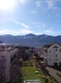The exterior view of buildings with a beautiful mountain backdrop.