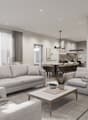 Spacious open-concept living room and dining area, with large windows, grey sofas, coffee table, and modern artwork on the wall. The kitchen is visible in the background, with a dining table and chairs. The space has a clean, minimalist design with neutra