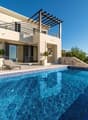 Modern villa, large windows, outdoor seating, pool, wooden pergola, large terrace