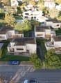 modern architecture with solar panels, balconies, swimming pools, parking area, and lush green surroundings