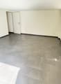 empty room, white walls, gray tiles, white doors, power outlet