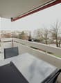 Balcony with table and chairs, covered balcony, grassy area