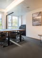 Two desks, chairs, small table, picture, lamp