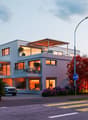 2 story house, white exterior, large windows, balcony, parking place