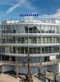 TECHNOPARK building, multiple floors, glass walls, curved design, green rooftop