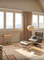 Leather couch, side table, floor lamp, dining table, leather chairs, carpet, large windows, curtains, painting
