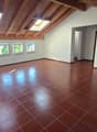 empty room, fireplace, wooden ceiling, brown tiles, windows