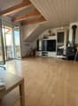wooden floor, large windows, balcony, TV, wooden beams, fireplace