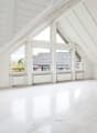 empty room, white walls, white floor, large windows, balcony outside, radiators