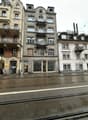 5 story building, balconies, stone exterior, windows, street front
