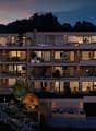 Multi-storey building, modern architecture, multiple balconies, landscaped garden, scenic view of the forest