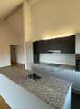 modern kitchen with granite countertop, stainless steel sink, built-in oven, dishwasher, wooden floor