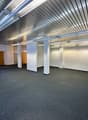 empty room, white walls, gray carpet, metal ceiling, wooden doors