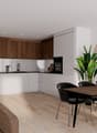 modern kitchen with wooden cabinets, white countertops, black chairs, wooden table, brown couch, wooden floor, white walls, plants, lamp, clock