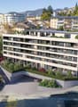Multi-story building with multiple balconies, raised ground floor, underground garage