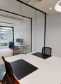 modern office room, glass walls, white desk, black chairs, computer, wooden floor