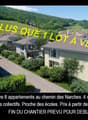 New residential development, multiple houses with balconies and solar panels, green surroundings, private driveways, communal gardens