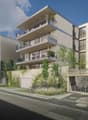 Modern multi-story building with balconies, wall greening, and garages.