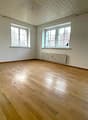 empty room, wooden floor, white walls, three windows, white ceiling, white radiator