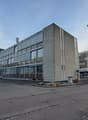 4 story office building, grey color, glass windows, parking lot, trees, street light