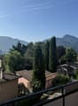 Balcony overlooking cityscape with mountains in the background