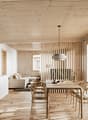 kitchen with island, dining table, chairs, living area with sofa, large windows