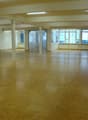wooden floor, multiple windows, pillars, fire extinguisher
