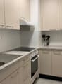 modern kitchen with granite countertops, stainless steel sink, electric stove, oven, and dishwasher
