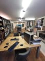 A room with desks, computers, keyboards, mice, and chairs.