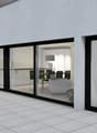 white wall, large sliding glass windows, tiled patio, view of outdoor dining area, green lawn