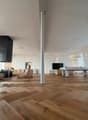modern living room, hardwood floors, large windows, modern furniture, central column, suspended lights