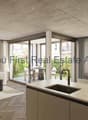Offene Wohnküche mit direktem Terrassenzugang und Betondecke