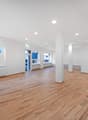 empty room, wooden floor, white walls, round window, glass door, radiators