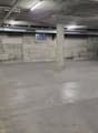 Large empty concrete floor, two pillars, small open window, metal beams