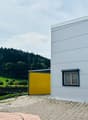 modern style house with large windows, yellow garage, small swimming pool