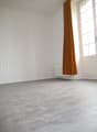 empty room, white walls, wooden floor, white radiator, window with white frame